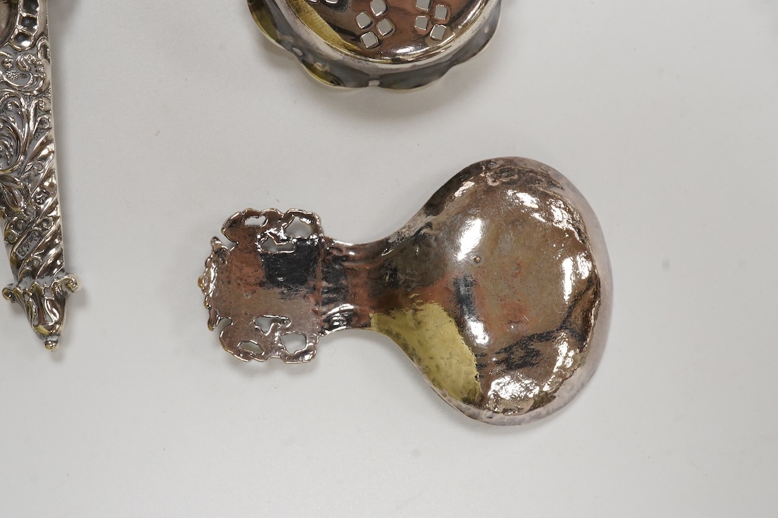 Small silver and white metal, including an Edwardian silver tea strainer, import marks for London, 1908, 15.7cm, a late Victorian silver sifter spoon, silver handled scissors with case, a white metal corkscrew and a whit